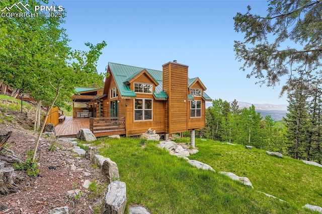 1527 S Pine Dr, Bailey, CO 80421 - back of house featuring a wooden deck, a chimney, and a metal roof
