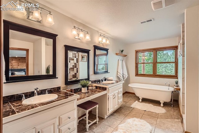 1527 S Pine Dr, Bailey, CO 80421 - bathroom with vanity, a textured ceiling, a freestanding bath, and tile patterned flooring
