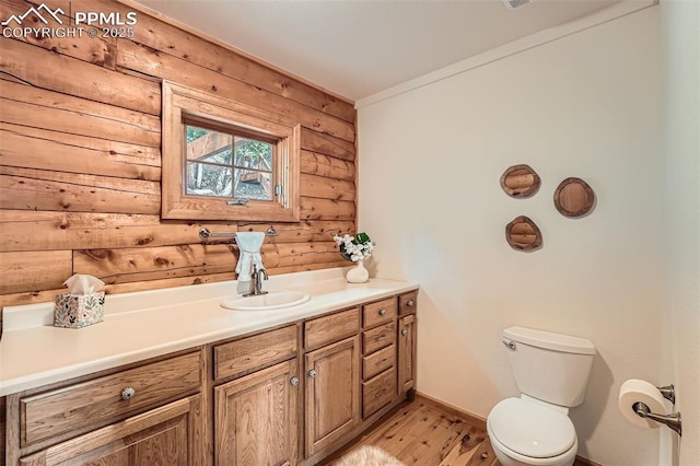 1527 S Pine Dr, Bailey, CO 80421 - bathroom featuring log walls, wood finished floors, and vanity