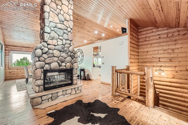 1527 S Pine Dr, Bailey, CO 80421 - living room featuring log walls, wood ceiling, hardwood / wood-style floors, a stone fireplace, and high vaulted ceiling