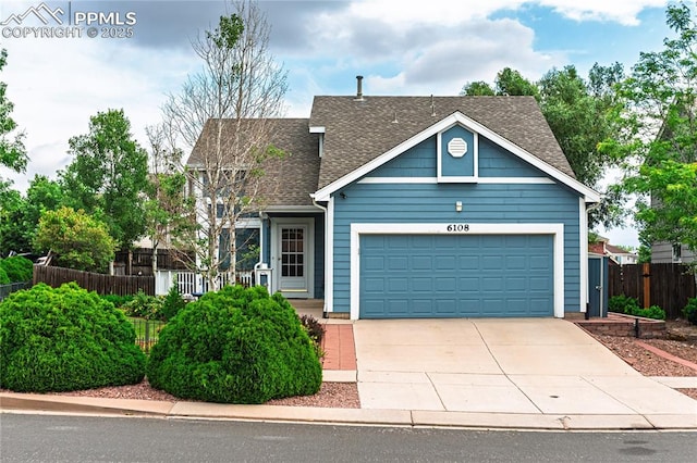 6108 Steed Way, Colorado Springs, CO 80922 - view of front of home with a shingled roof, concrete driveway, and an attached garage