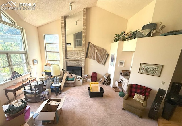 945 Marlstone Pl, Colorado Springs, CO 80904 - carpeted living room with a fireplace, a textured ceiling, and high vaulted ceiling