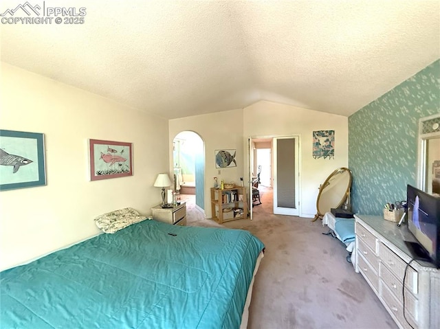 945 Marlstone Pl, Colorado Springs, CO 80904 - bedroom with arched walkways, carpet floors, lofted ceiling, and a textured ceiling