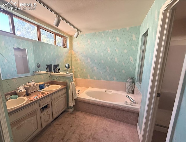 945 Marlstone Pl, Colorado Springs, CO 80904 - full bathroom featuring wallpapered walls, a bath, double vanity, and rail lighting