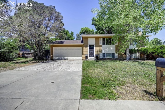 4110 Undimmed Cir, Colorado Springs, CO 80917 - split level home with a front lawn, an attached garage, and concrete driveway