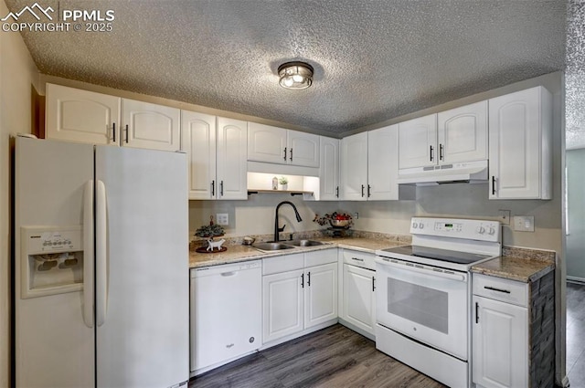 4110 Undimmed Cir, Colorado Springs, CO 80917 - kitchen with white appliances, under cabinet range hood, white cabinets, dark wood finished floors, and a textured ceiling