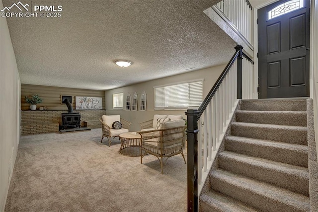 4110 Undimmed Cir, Colorado Springs, CO 80917 - living room with stairway, carpet flooring, a textured ceiling, and a wood stove