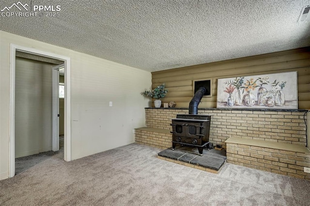 4110 Undimmed Cir, Colorado Springs, CO 80917 - unfurnished living room with a textured ceiling, carpet floors, and a wood stove