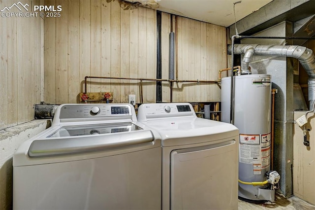 4110 Undimmed Cir, Colorado Springs, CO 80917 - washroom featuring gas water heater, washing machine and dryer, and wood walls
