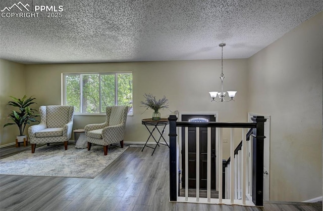 4110 Undimmed Cir, Colorado Springs, CO 80917 - sitting room featuring a chandelier, a textured ceiling, and wood finished floors