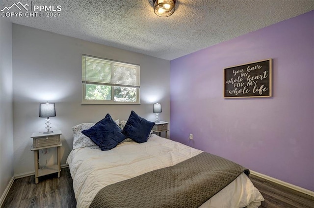 4110 Undimmed Cir, Colorado Springs, CO 80917 - bedroom featuring wood finished floors and a textured ceiling