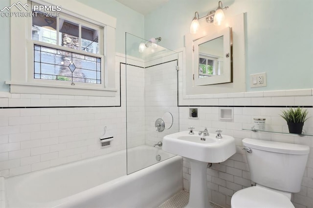 1401 N Tejon St, Colorado Springs, CO 80907 - bathroom with tile walls,  shower combination, and a wainscoted wall