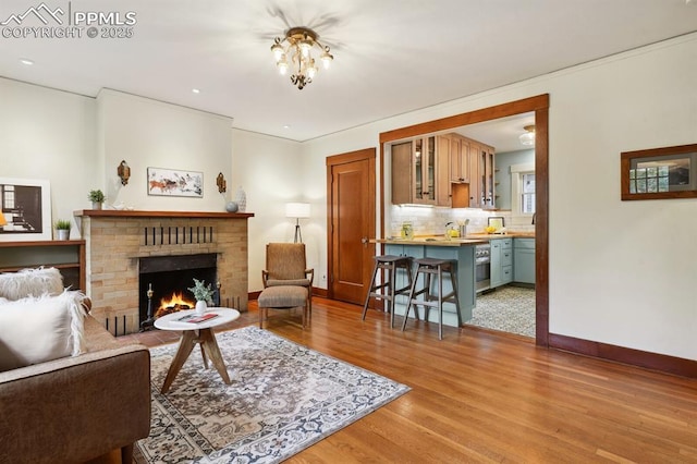 1401 N Tejon St, Colorado Springs, CO 80907 - living area featuring light wood-type flooring and a brick fireplace