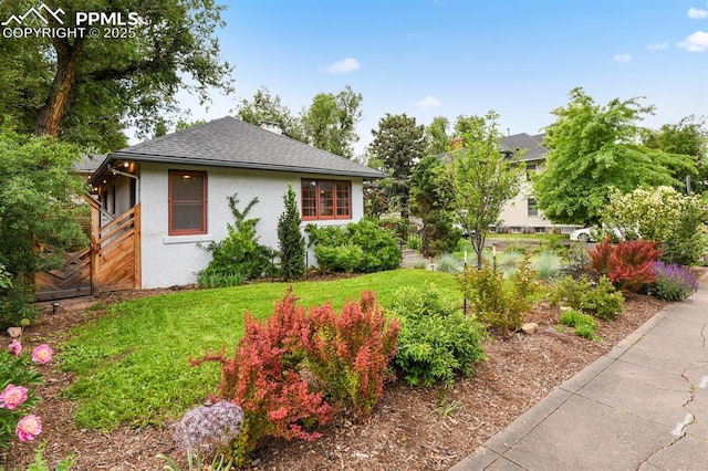 1401 N Tejon St, Colorado Springs, CO 80907 - view of home's exterior featuring stucco siding, roof with shingles, and a lawn