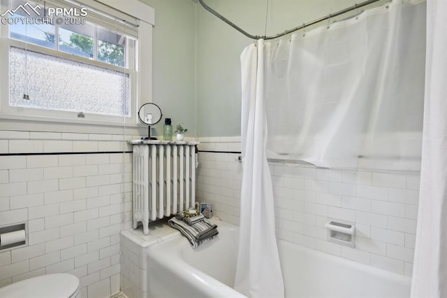 1401 N Tejon St, Colorado Springs, CO 80907 - bathroom with tile walls, radiator, and shower / tub combo with curtain