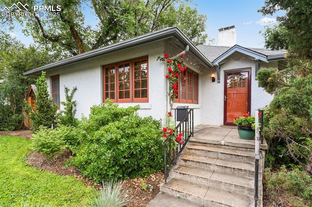1401 N Tejon St, Colorado Springs, CO 80907 - view of front of property featuring stucco siding and a chimney