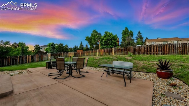 440 Torrey Pines Way, Colorado Springs, CO 80921 - patio terrace at dusk featuring outdoor dining space, a patio, and a fenced backyard