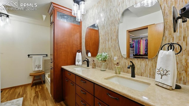 440 Torrey Pines Way, Colorado Springs, CO 80921 - full bath with double vanity, wood finished floors, and a tub