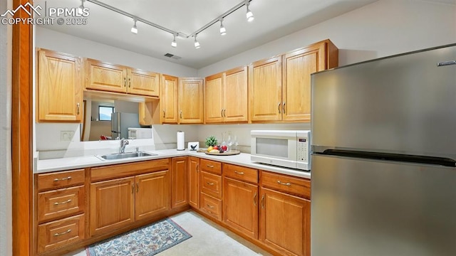 440 Torrey Pines Way, Colorado Springs, CO 80921 - kitchen featuring freestanding refrigerator, white microwave, light countertops, and track lighting