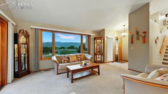 440 Torrey Pines Way, Colorado Springs, CO 80921 - living room featuring a mountain view, stairway, light colored carpet, and a chandelier