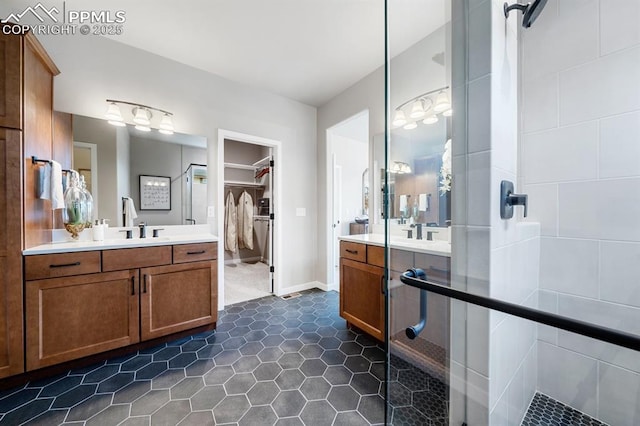 9996 Antelope Ravine Dr, Colorado Springs, CO 80908 - full bath with vanity, a spacious closet, a stall shower, and tile patterned floors
