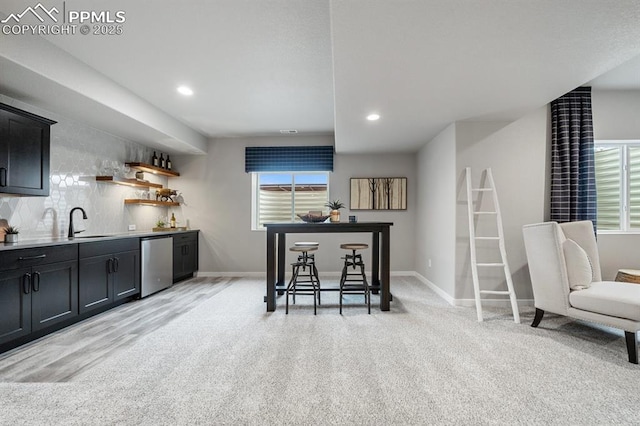 9996 Antelope Ravine Dr, Colorado Springs, CO 80908 - kitchen featuring dishwasher, healthy amount of natural light, recessed lighting, dark cabinetry, and light carpet