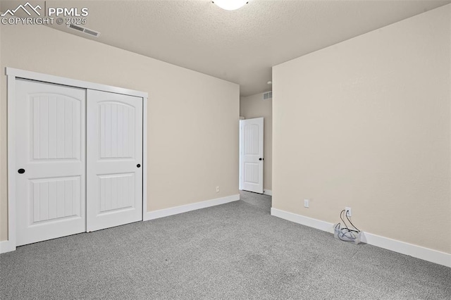 5060 Galloping Goose Way, Colorado Springs, CO 80924 - unfurnished bedroom featuring carpet floors, a textured ceiling, and a closet
