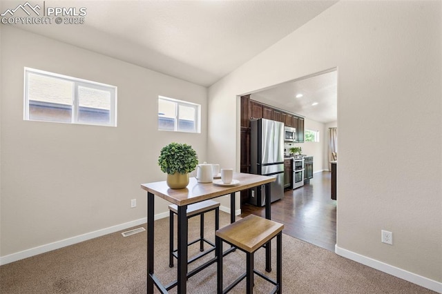 5060 Galloping Goose Way, Colorado Springs, CO 80924 - dining room featuring lofted ceiling and dark carpet