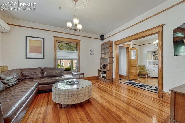 2302 W Kiowa St, Colorado Springs, CO 80904 - living area featuring wood finished floors, a chandelier, and a wall mounted air conditioner