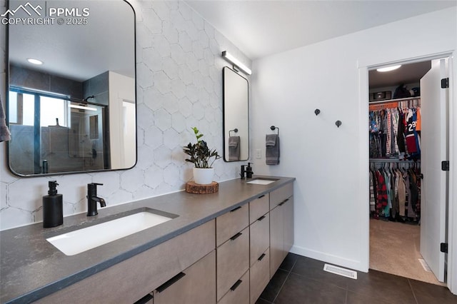 4841 Hanging Lake Cir, Colorado Springs, CO 80924 - bathroom featuring tile patterned floors, double vanity, a stall shower, and a spacious closet