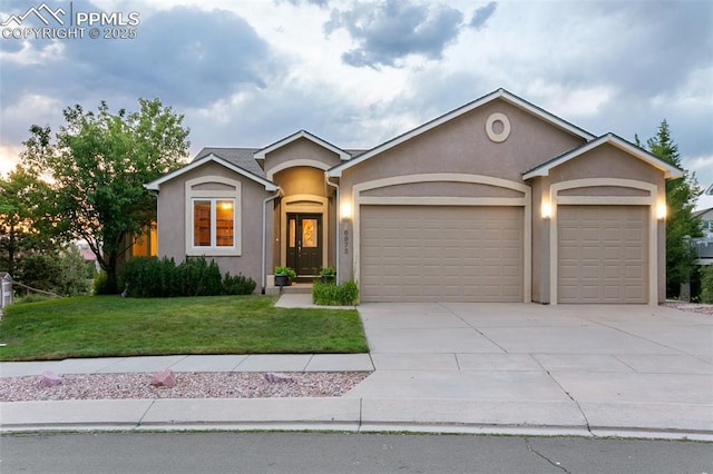 6972 Granite Peak Dr, Colorado Springs, CO 80923 - single story home with an attached garage, stucco siding, concrete driveway, and a front lawn