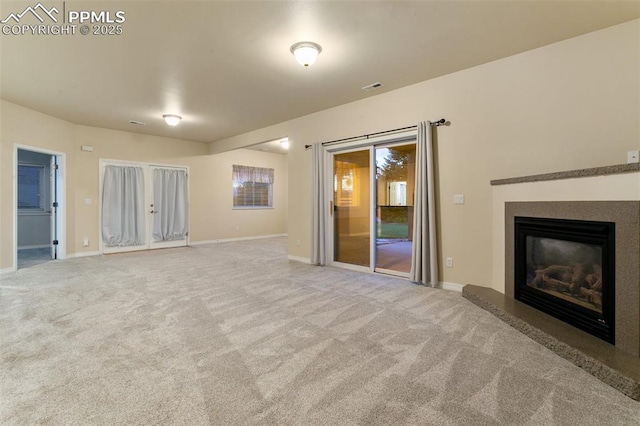 6972 Granite Peak Dr, Colorado Springs, CO 80923 - unfurnished living room featuring carpet flooring and a glass covered fireplace