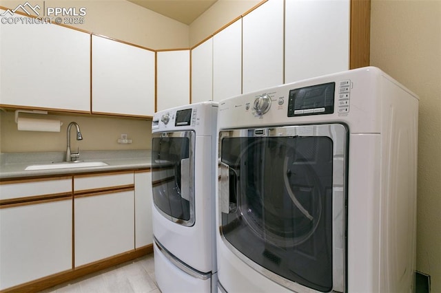 6972 Granite Peak Dr, Colorado Springs, CO 80923 - laundry area featuring washing machine and clothes dryer and cabinet space