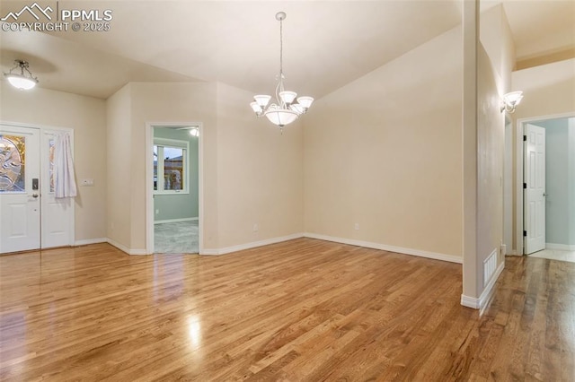 6972 Granite Peak Dr, Colorado Springs, CO 80923 - unfurnished room with light wood-style flooring, a chandelier, and vaulted ceiling
