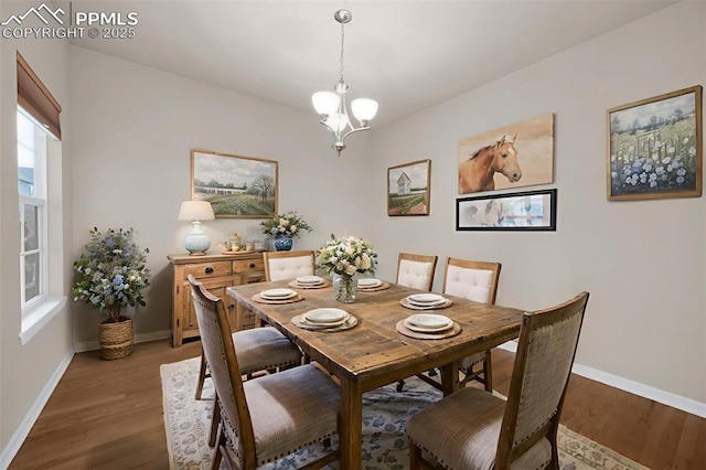 7665 Manston Dr, Colorado Springs, CO 80920 - dining area featuring wood finished floors and a chandelier