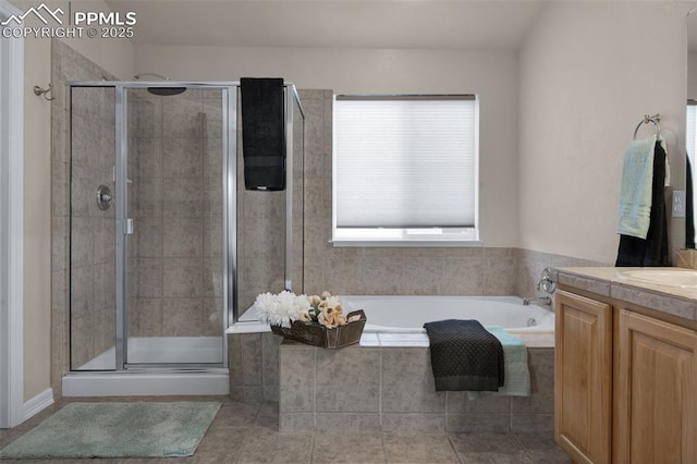7665 Manston Dr, Colorado Springs, CO 80920 - bathroom with vanity, a bath, a shower stall, and tile patterned floors
