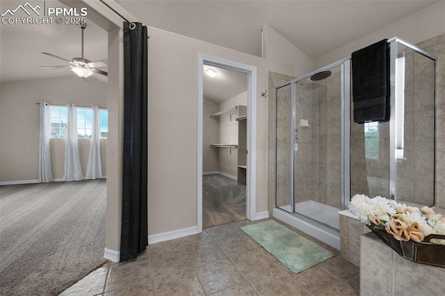 7665 Manston Dr, Colorado Springs, CO 80920 - bathroom featuring vaulted ceiling, ceiling fan, a shower stall, a walk in closet, and tile patterned flooring