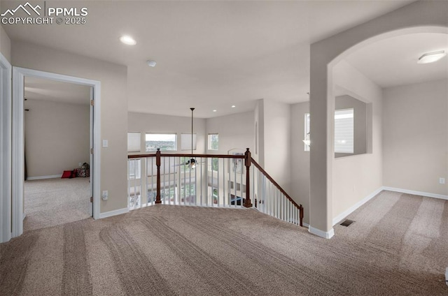 7665 Manston Dr, Colorado Springs, CO 80920 - carpeted empty room with arched walkways and recessed lighting