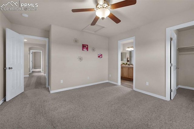 7665 Manston Dr, Colorado Springs, CO 80920 - unfurnished bedroom featuring light carpet, a spacious closet, ensuite bath, and attic access