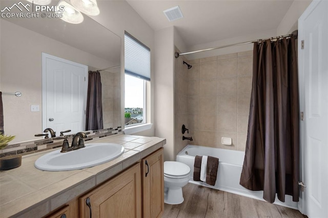 7665 Manston Dr, Colorado Springs, CO 80920 - bathroom with vanity, shower / tub combo with curtain, and wood finished floors