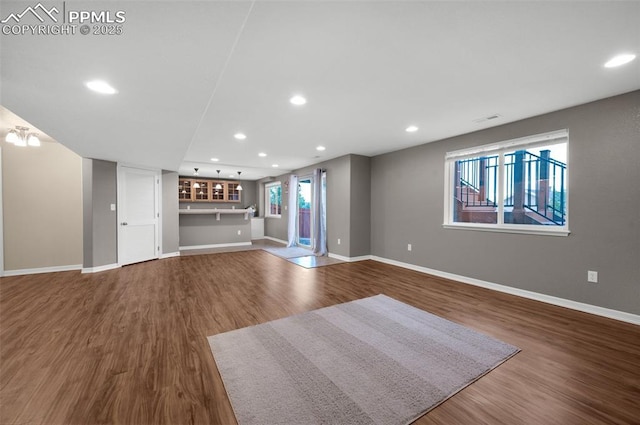 7665 Manston Dr, Colorado Springs, CO 80920 - unfurnished living room with wood finished floors and recessed lighting