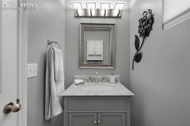 7665 Manston Dr, Colorado Springs, CO 80920 - bathroom with vanity and a textured wall