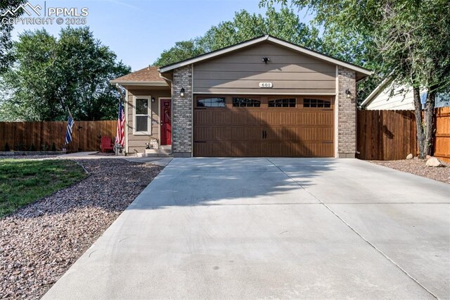 601 Harvest Field Way, Fountain, CO 80817 - view of front of house with a garage, concrete driveway, and brick siding