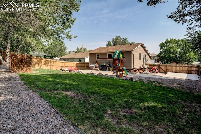 601 Harvest Field Way, Fountain, CO 80817 - rear view of house featuring a playground, a patio, and a fenced backyard