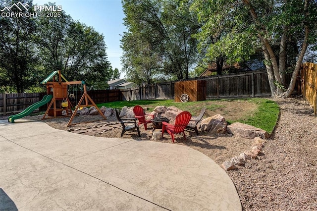 601 Harvest Field Way, Fountain, CO 80817 - fenced backyard with a playground, a patio, and an outdoor fire pit