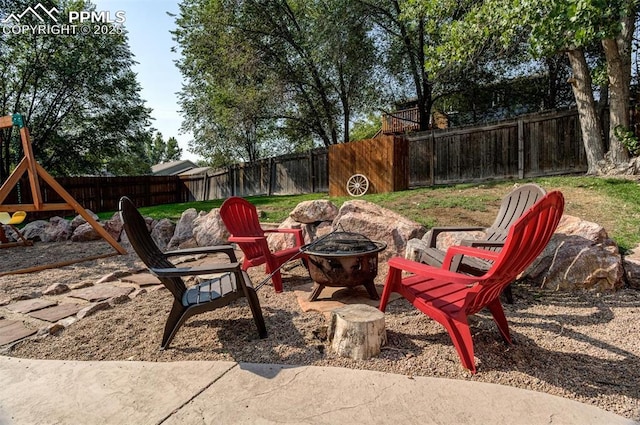601 Harvest Field Way, Fountain, CO 80817 - fenced backyard with a fire pit