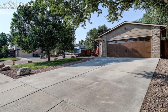601 Harvest Field Way, Fountain, CO 80817 - view of side of property with brick siding, driveway, and a garage