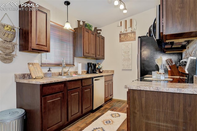 601 Harvest Field Way, Fountain, CO 80817 - kitchen featuring appliances with stainless steel finishes, wood finished floors, light countertops, decorative light fixtures, and tasteful backsplash