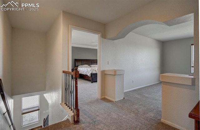 9444 Castle Oaks Dr, Fountain, CO 80817 - corridor featuring an upstairs landing, carpet flooring, and arched walkways