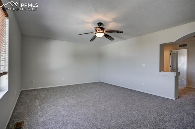 9444 Castle Oaks Dr, Fountain, CO 80817 - unfurnished room with a ceiling fan, carpet floors, arched walkways, and a textured ceiling